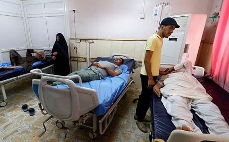 People receive treatment for consuming contaminated water at a hospital in Basra, Iraq, in July 2018. File photo: AFP