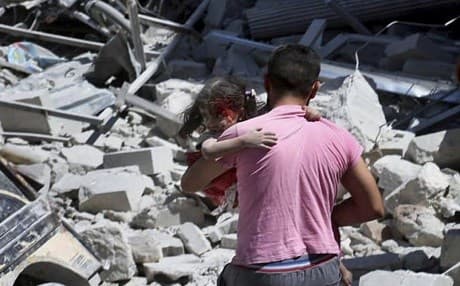 A Syrian man carries an injured girl after an airstrike hit the northern town of Ariha, Idlib province, Syria on July 27 2019. Photo: Syrian Civil Defense White Helmets via AP  
