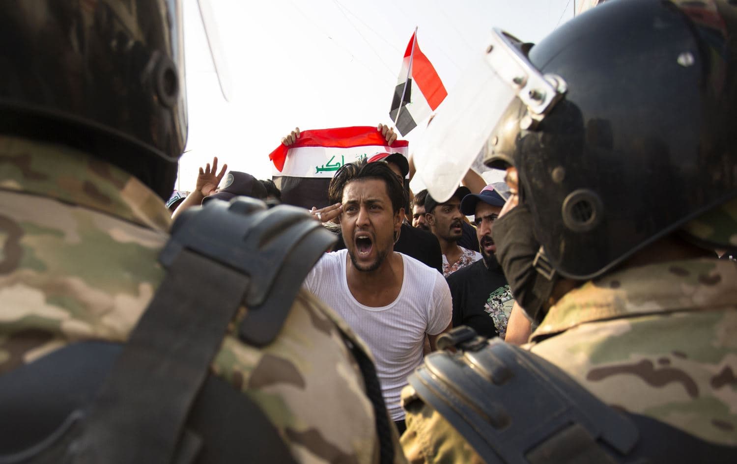 An Iraqi protestor gestures at security forces during an October 2, 2019 demonstration in the southern city of Basra. Photo: AFP / Hussein Faleh