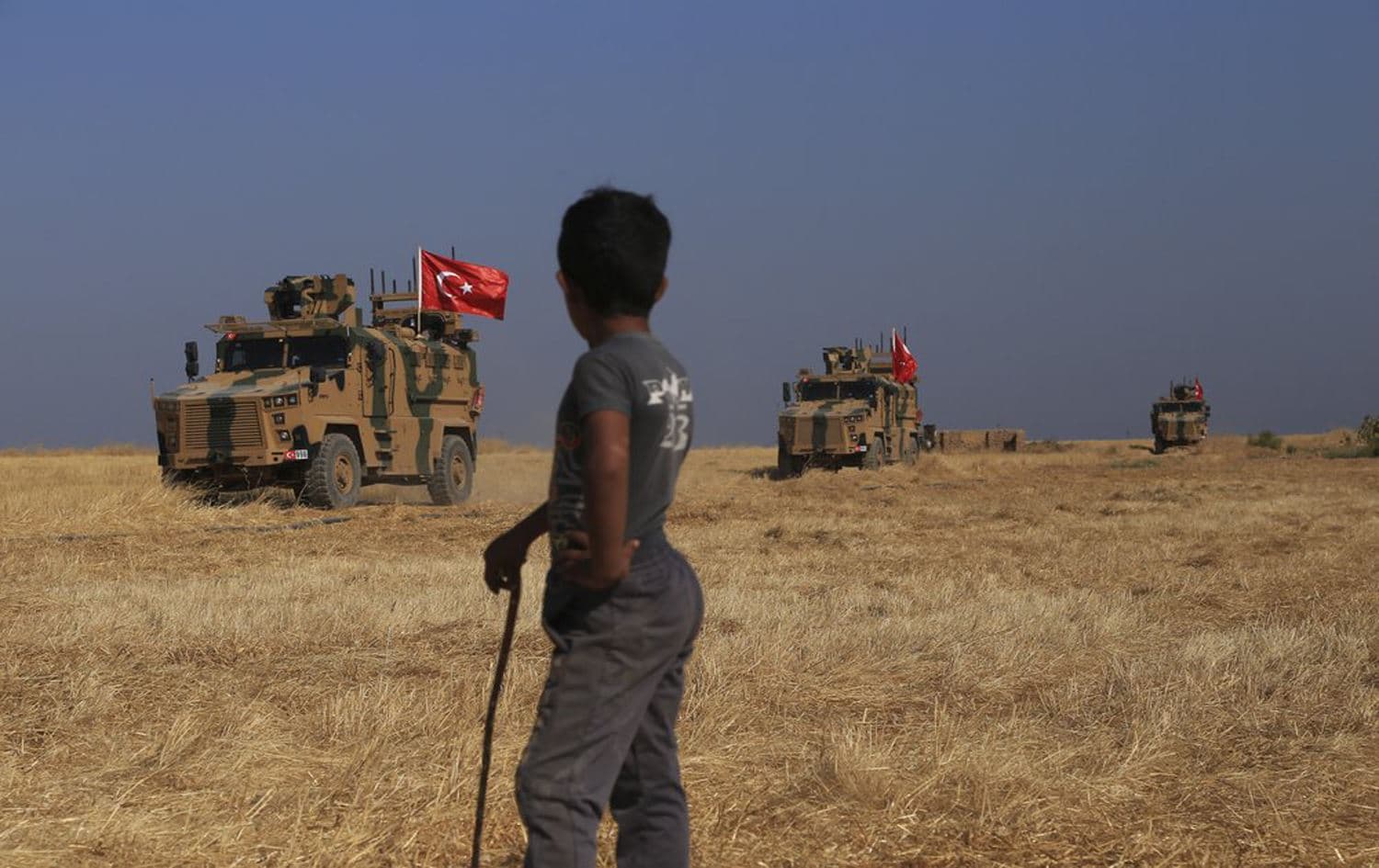 Turkish armored vehicles conduct a joint ground patrol with American forces in the so-called "safe zone" on the Syrian side of the border with Turkey, near the town of Tal Abyad, northeastern Syria on October 4, 2019. Photo: AP / Baderkhan Ahmad
