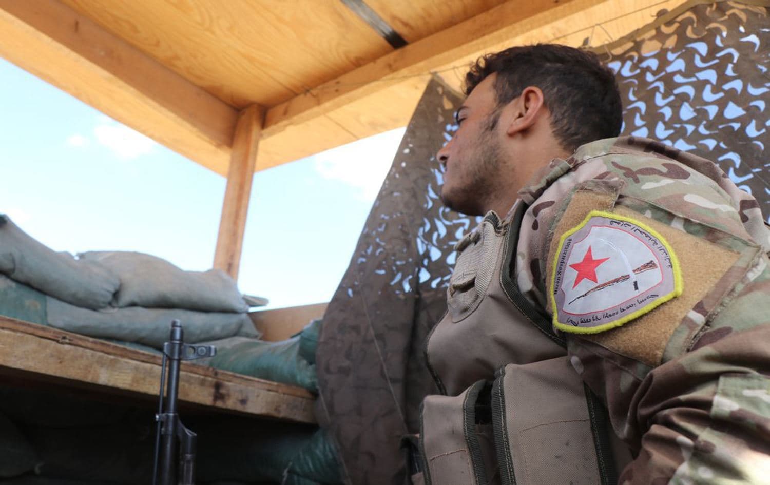 A fighter from the Kurdish-led Syrian Democratic Forces (SDF) stands guard inside a post where US troops were based, in Tal Abyad at the Syrian-Turkish border on October 7, 2019. File photo: AP 
