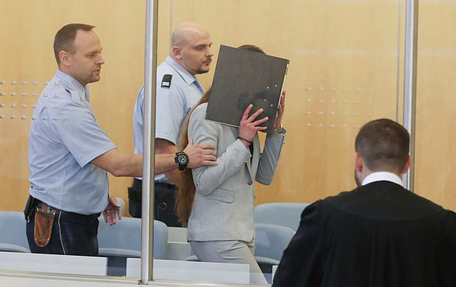 Sarah O. conceals her face in a Dusseldorf courtroom on October 16, 2019 where she is facing charge connected to enslavement of three Yezidi women. Photo: AP