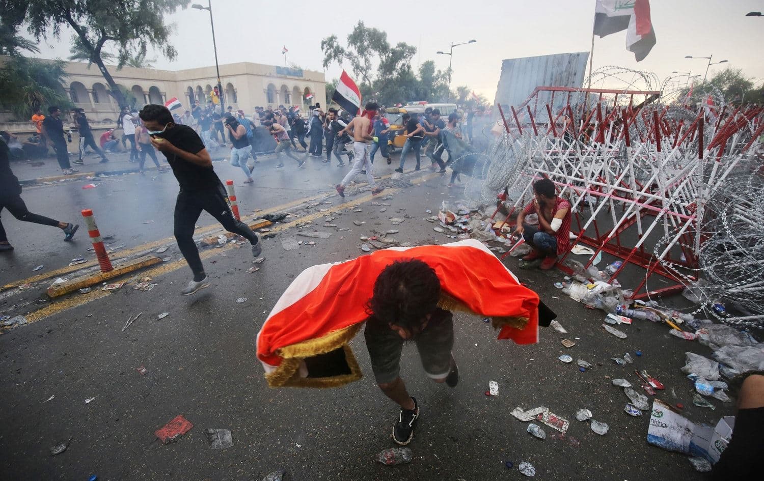  Iraqi protesters run for cover from teargas canisters fired by security forces during an anti-government demonstration on Al-Jumhuriya Bridge in the Iraqi capital Baghdad on October 25, 2019. Photo:AFP