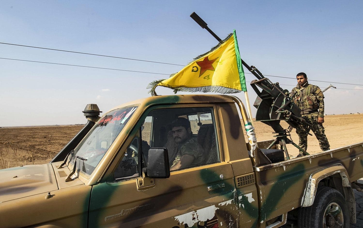  Fighters from the Syrian Democratic Forces (SDF) prepare to withdraw from the Sanjak Saadoun border area near the northern Syrian town of Amuda on October 27, 2019. Photo: AFP / Delil Souleiman