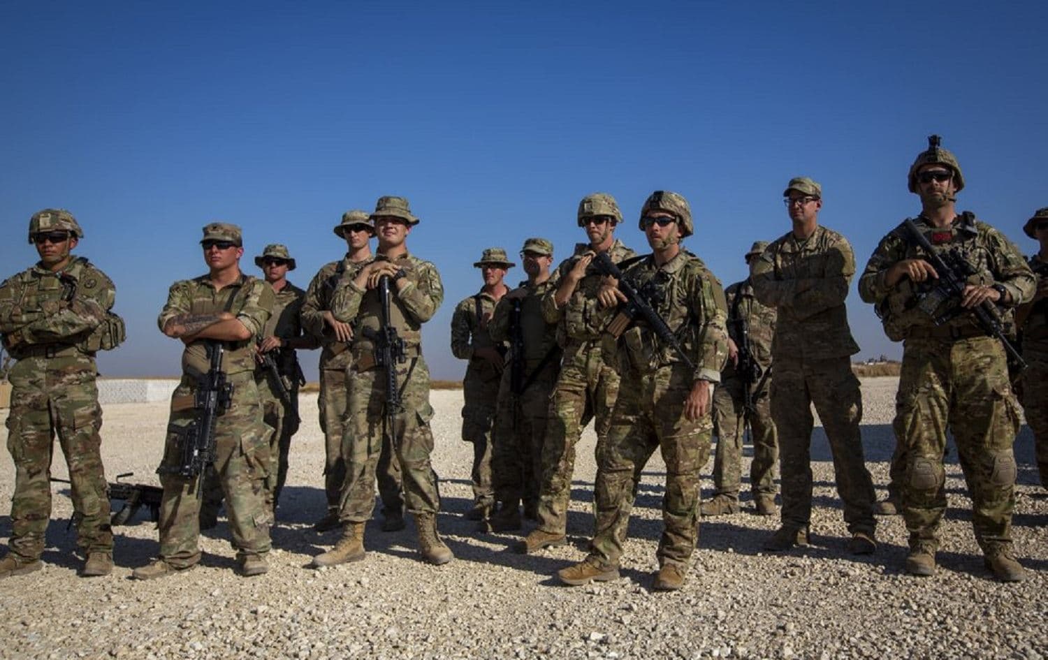 Crewmen of Bradley fighting vehicles stand guard at a US military base at an undisclosed location in northeastern Syria on November 11, 2019. Photo: AP / Darko Bandic