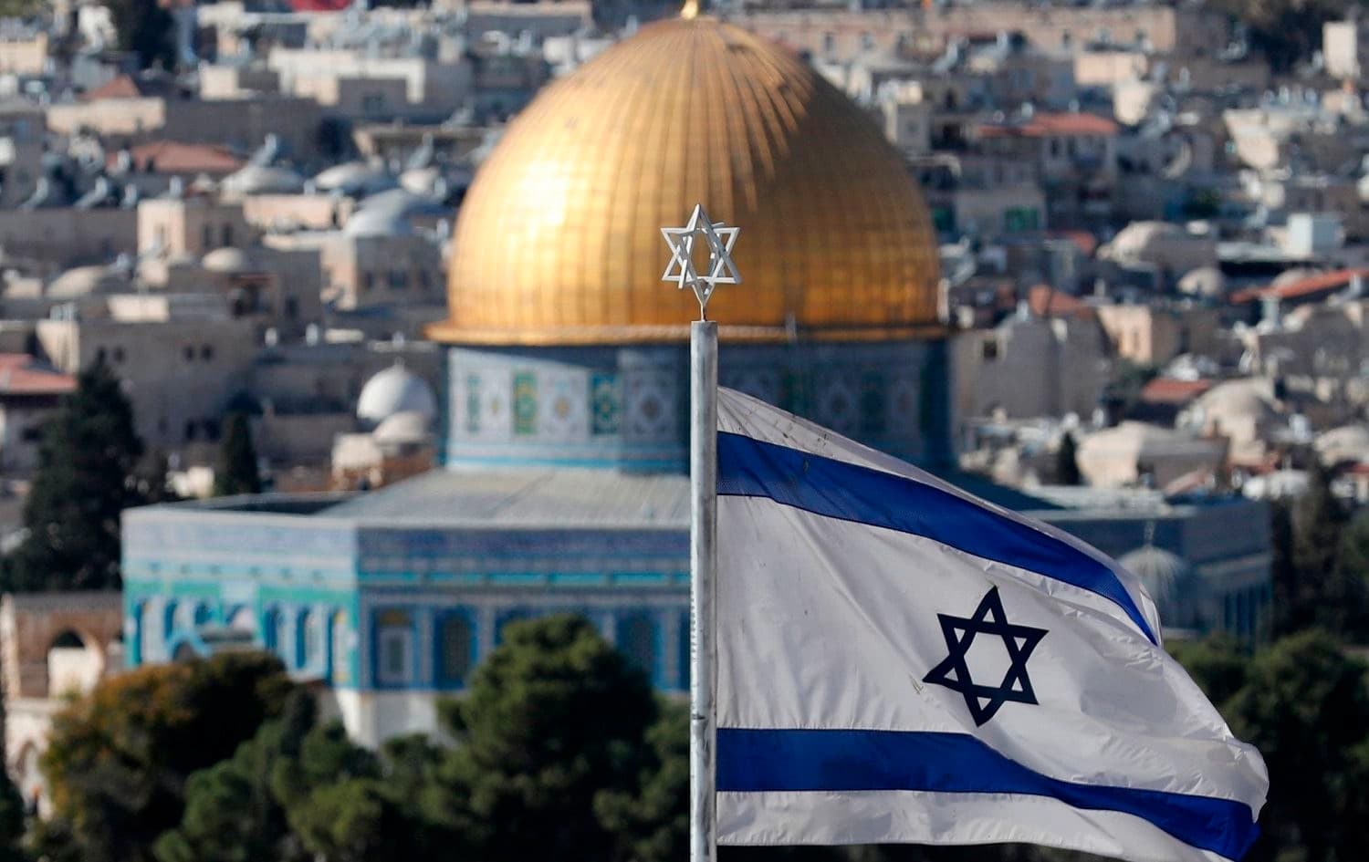 An Israeli flag flutters at Mount of Olives with the Old City of Jerusalem and its Dome of the Rock mosque in the centre, November 26, 2019. File photo: Ahmad Gharabli / AFP
