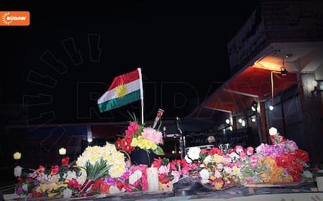 A Kurdish flag and flowers in Khanaqin at the site of a suicide bombing that killed 20 people at a PUK election rally in April. Photo: Rudaw