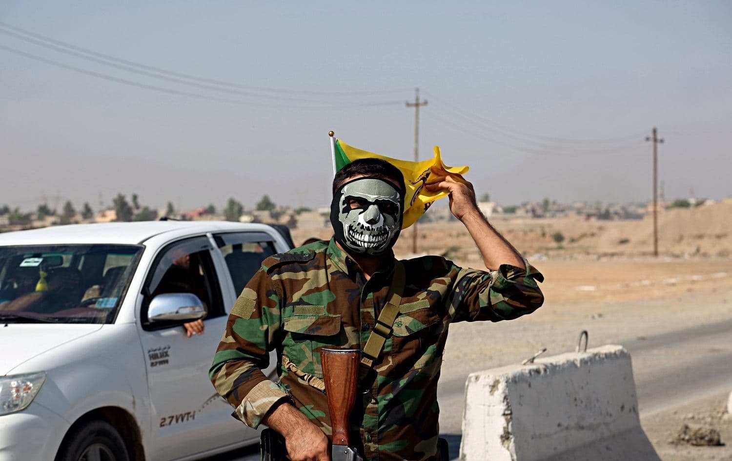 A fighter with Popular Mobilization Forces stands guard in Tuz Khormato, Saladin province on October 16, 2017. File Photo: AP
