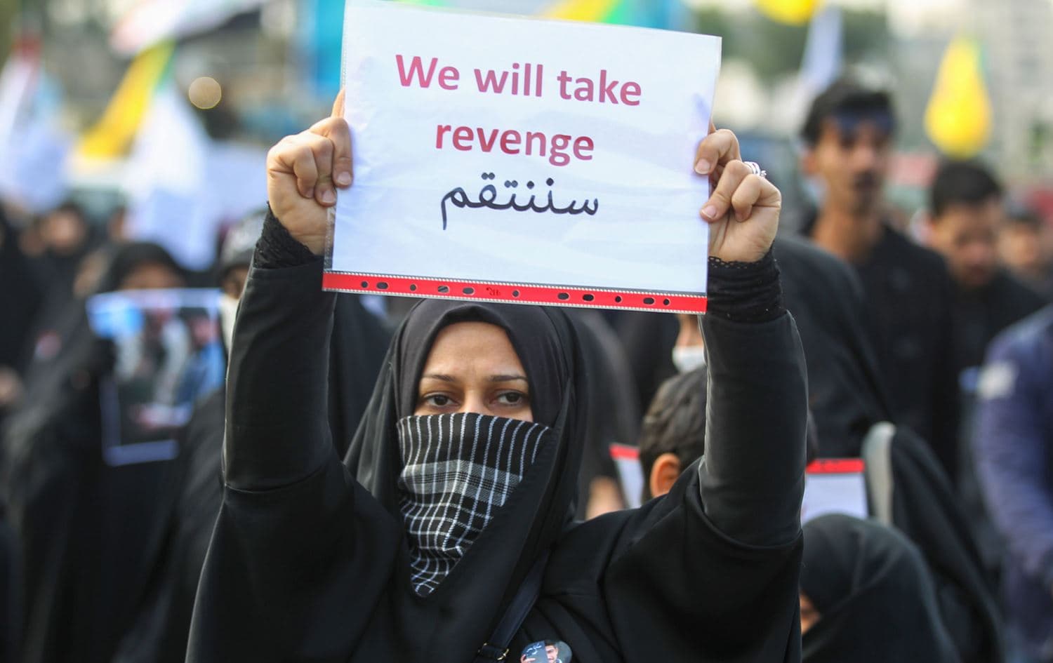 An Iraqi woman holds a placard during the funeral of Iranian military commander Qasem Soleimani, Iraqi paramilitary chief Abu Mahdi al-Muhandis and eight others in Baghdad's district of al-Jadriya, in Baghdad's high-security Green Zone, on January 4, 2020. Photo: AFP / Ahmad al-Rubaye