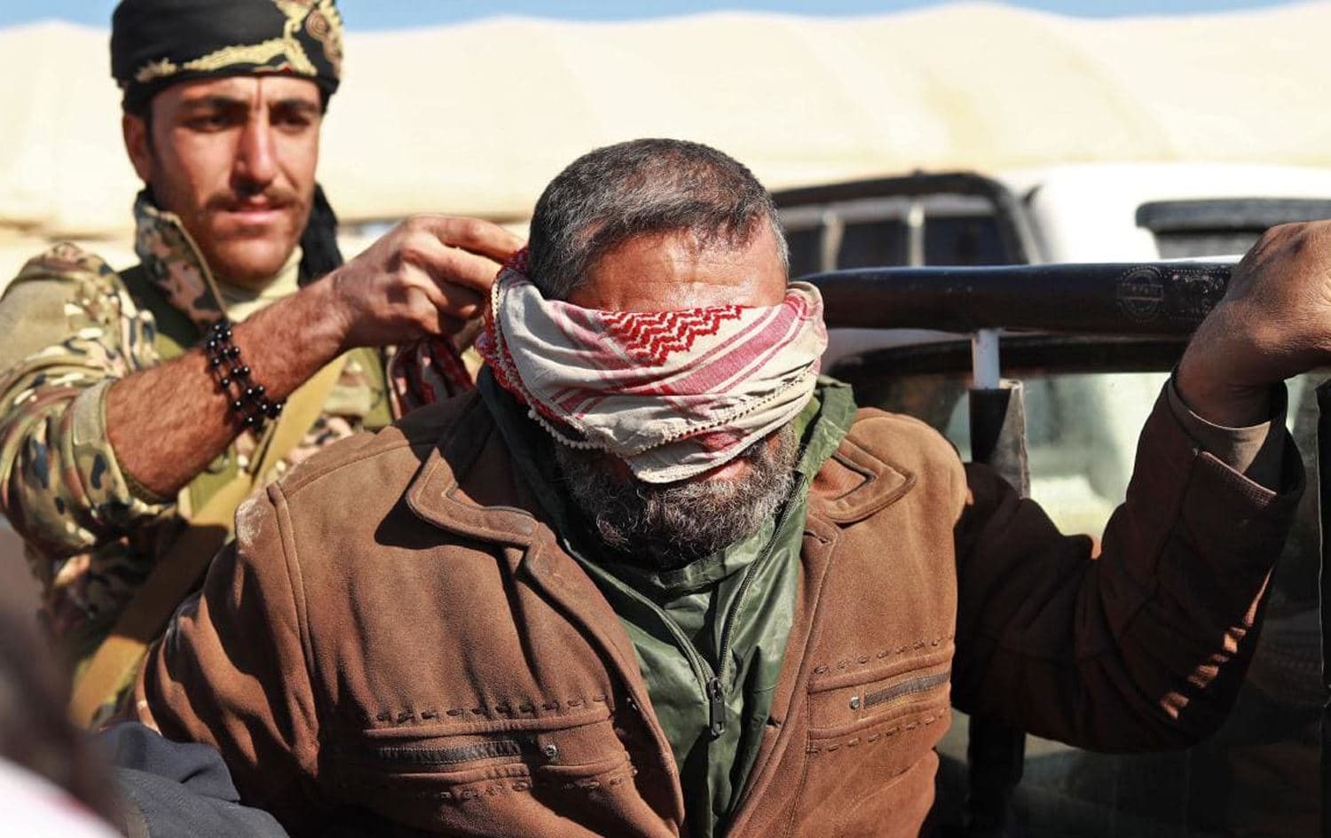 An ISIS fighter in custody of the Syrian Democratic Forces (SDF) forces in Baghouz, Syria. (AFP)