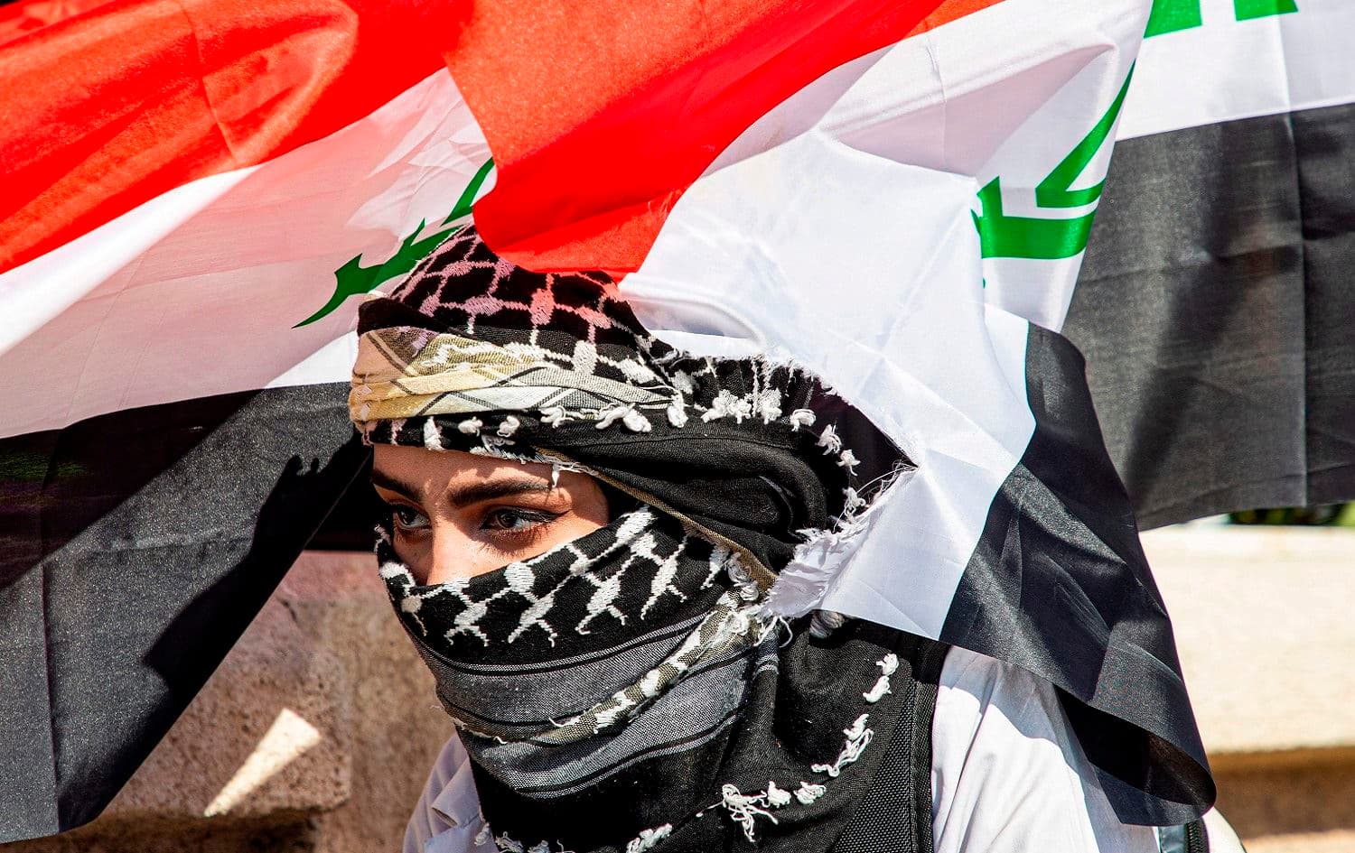An Iraqi student takes part in a drama scene re-enacting recent events of clashes between security forces and anti-government protesters in the southern Iraqi city of Basra on January 19, 2020. Photo: Hussein Faleh / AFP