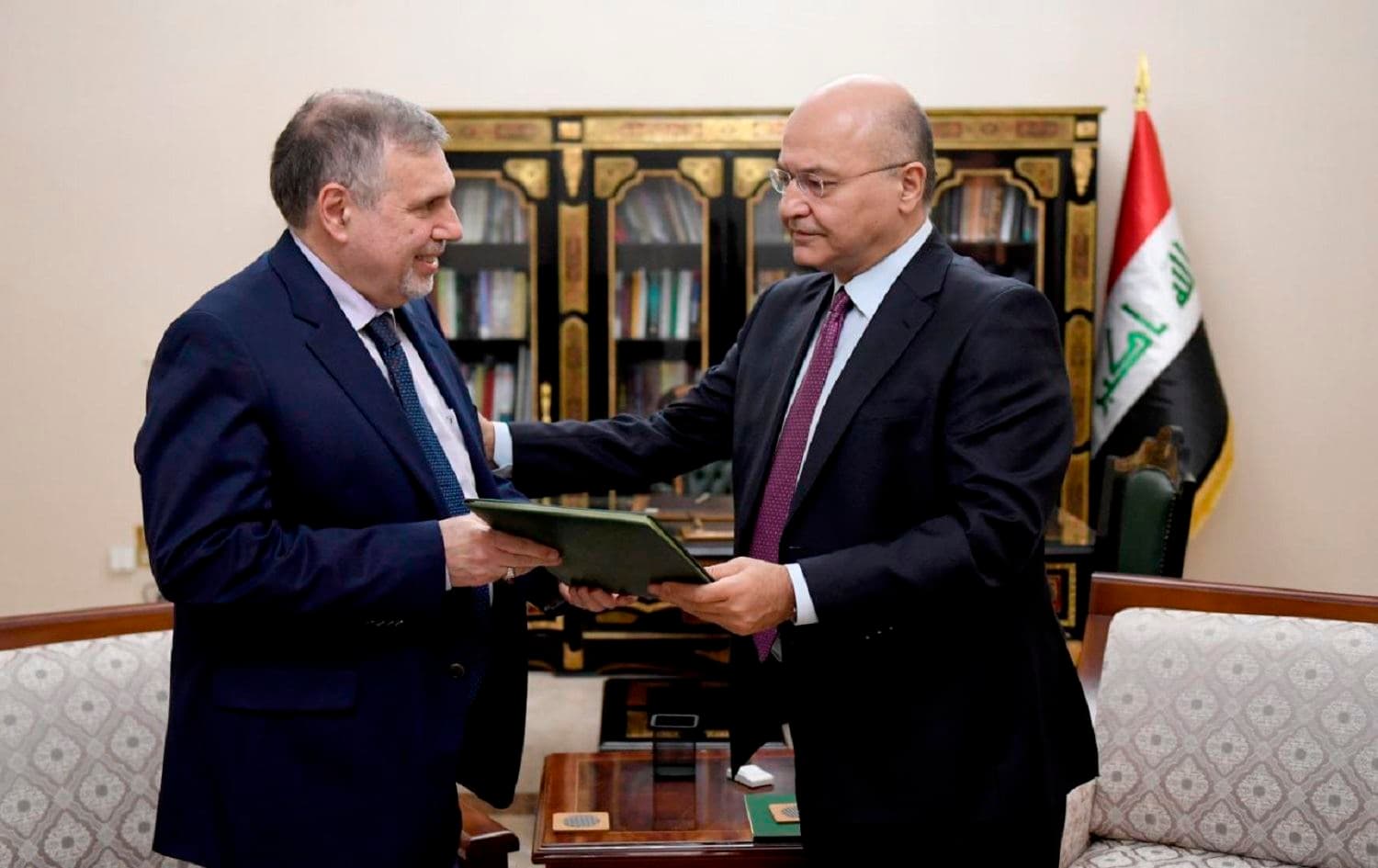 Iraqi President Barham Salih instructs newly appointed Prime Minister Mohammed Allawi in Baghdad on February 1 2020. Photo: Iraqi Presidency Media Office/AP