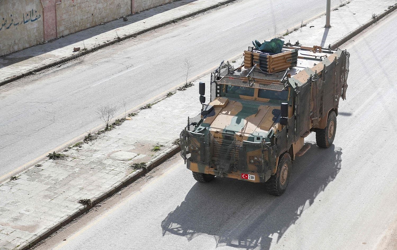 A Turkish military convoy of tanks and armoured vehicles passes near the city of Idlib in northwestern Syria, near the Syria-Turkey border, February 8, 2020. Photo: Omar Haj Kadour / AFP 