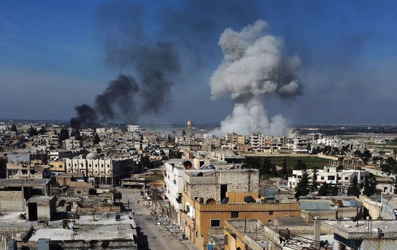 Smoke billows over the town of Saraqib in the eastern part of the Idlib province in northwestern Syria, following bombardment by Syrian government forces, February 27, 2020. Photo: Aref Tammawi / AFP 