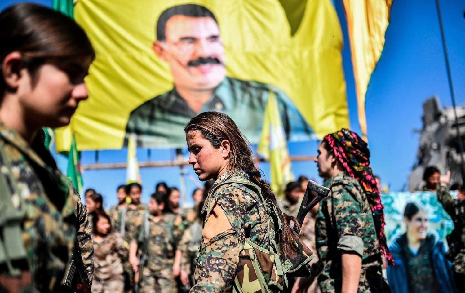 A large image of Abdullah Ocalan looks out over YPJ fighters in central Raqqa after the city was liberated from ISIS in October 2017. File photo: Bulent Kilic / AFP 