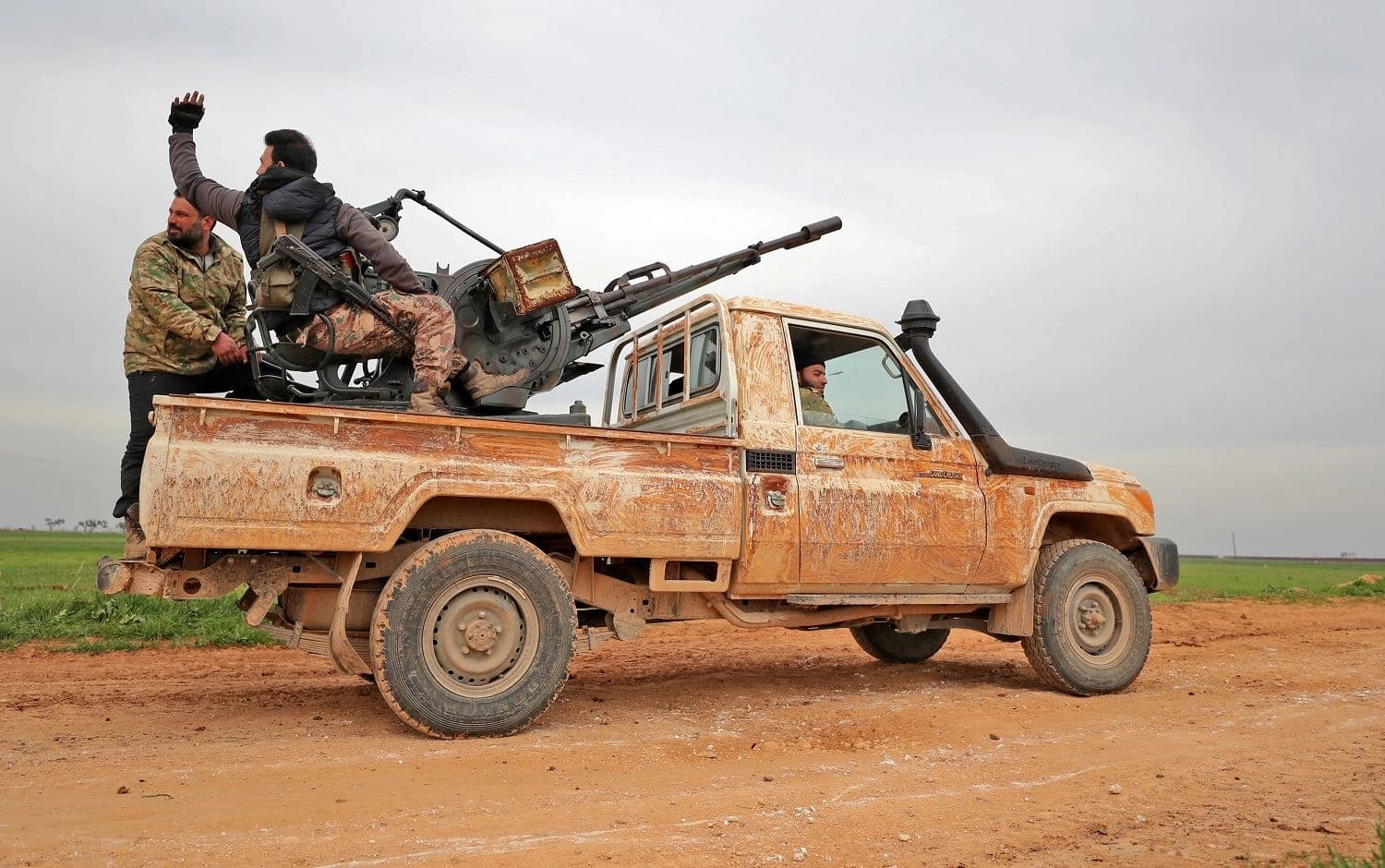 Turkish-backed Syrian rebels drive down a road near the town Taftanaz in northeastern Idlib province on February 28, 2020. Photo: Omar Haj Kadour / AFP