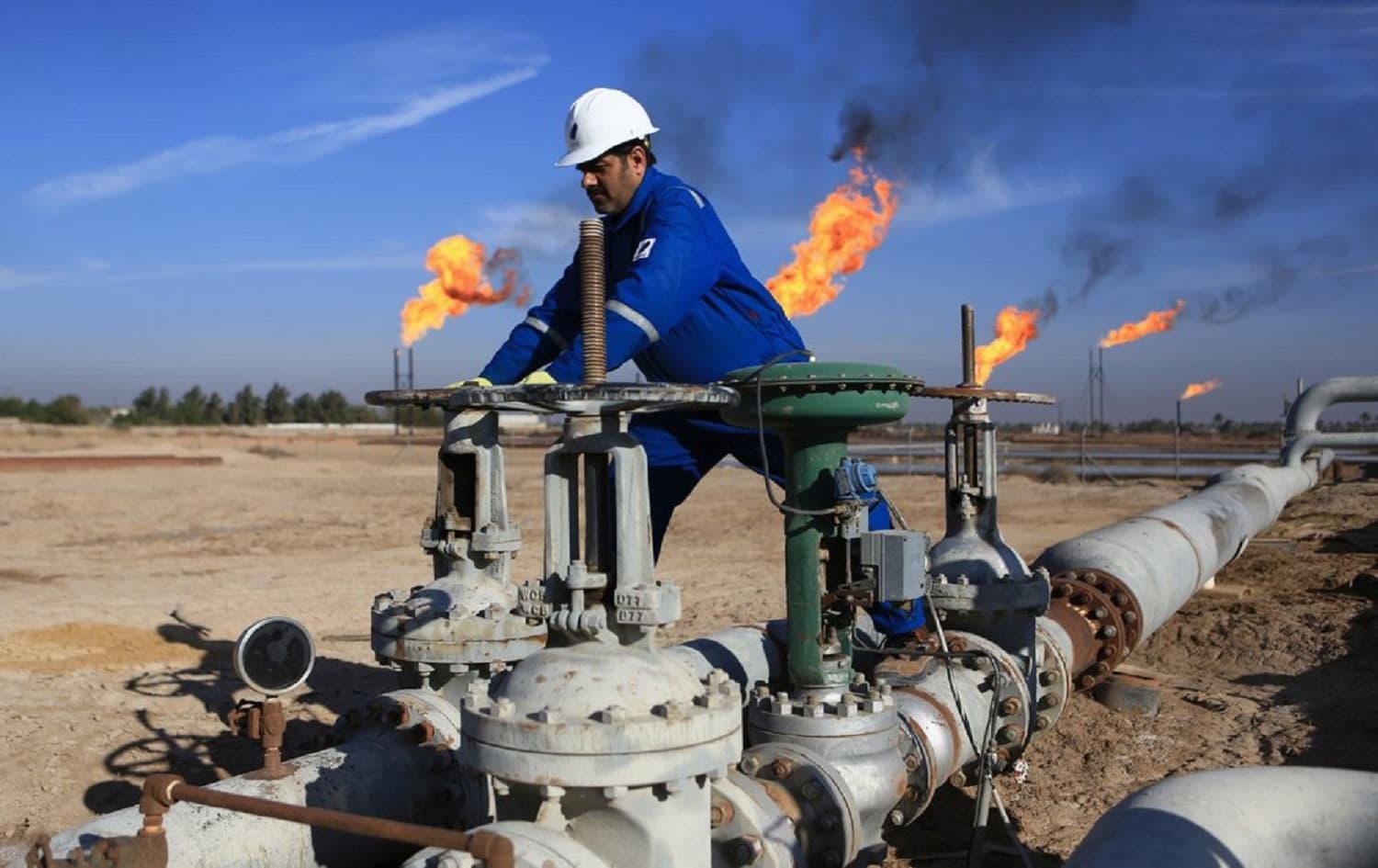 A worker operates valves in Nihran Bin Omar field north of Basra, Iraq. File photo: Nabil al-Jurani/AP 