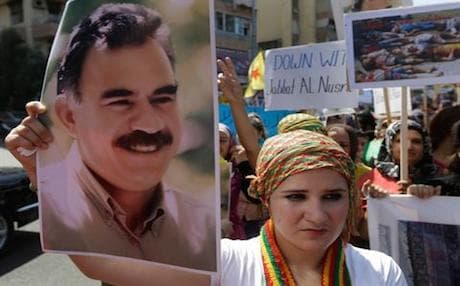 A supporter holds up a picture of PKK leader Abdullah Ocalan. Photo: AP