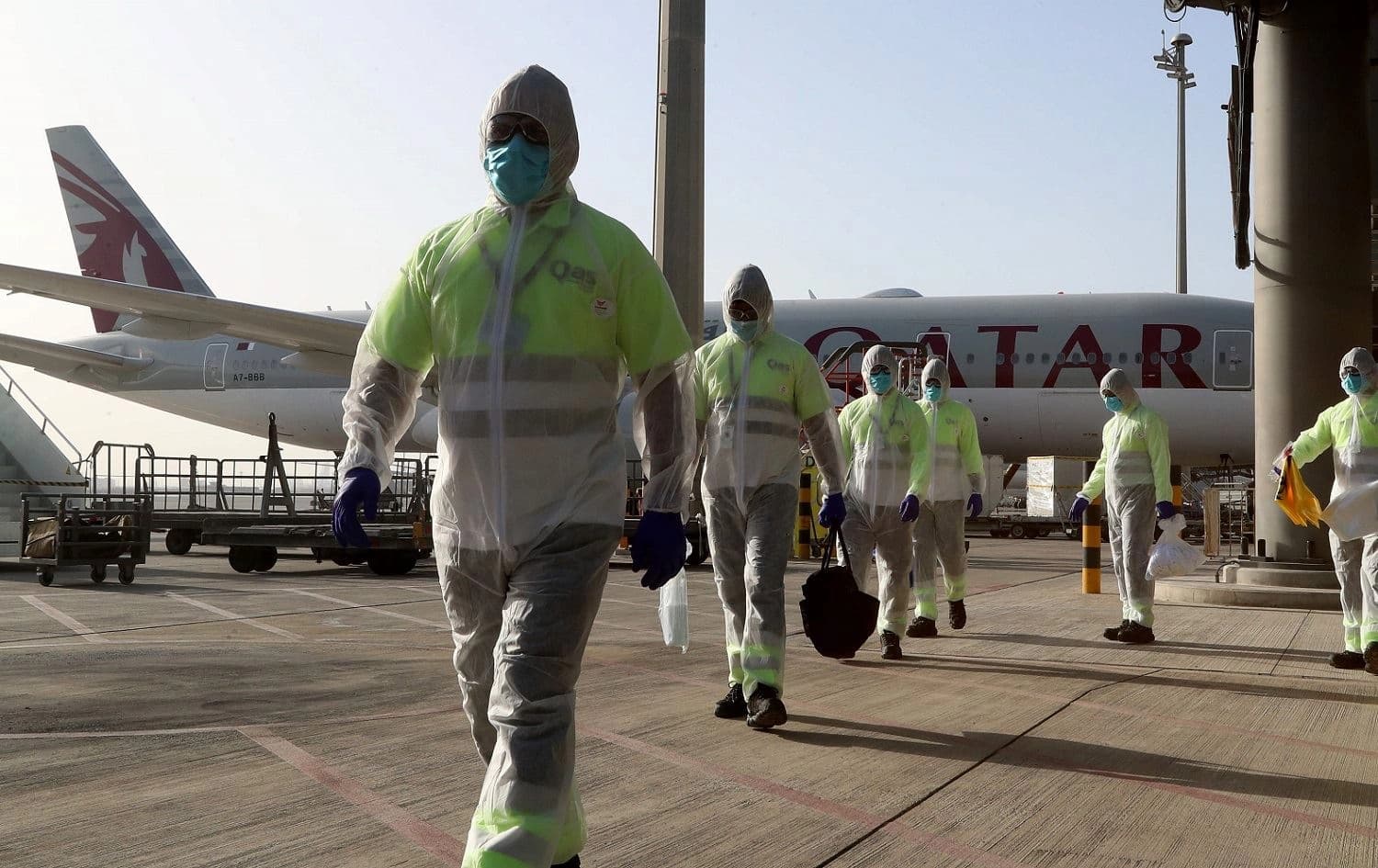 Employees of Qatar Aviation Services (QAS) sanitize an aircraft at Hamad International Airport in the Qatari capital Doha, April 1, 2020. Photo: Karim Jaafar / AFP