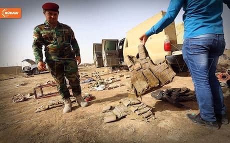 Kurdish Peshmergas inspecting uniforms and equipment left behind by the Iraqi army in Mosul. Photo: Rudaw