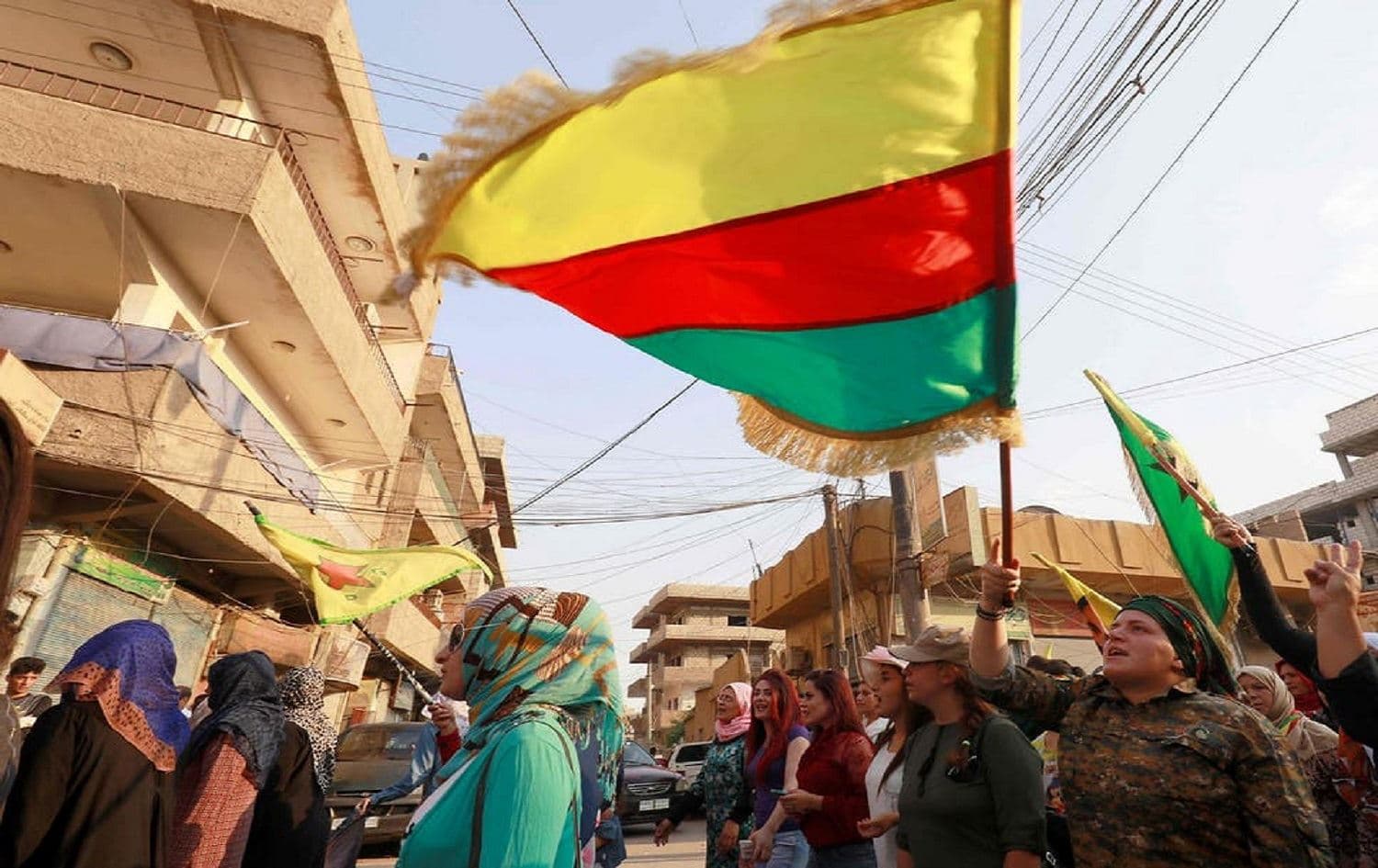 Syrian-Kurdish demonstrators wave Kurdish flags at a protest in Qamishli on June 23, 2018. File photo: AFP