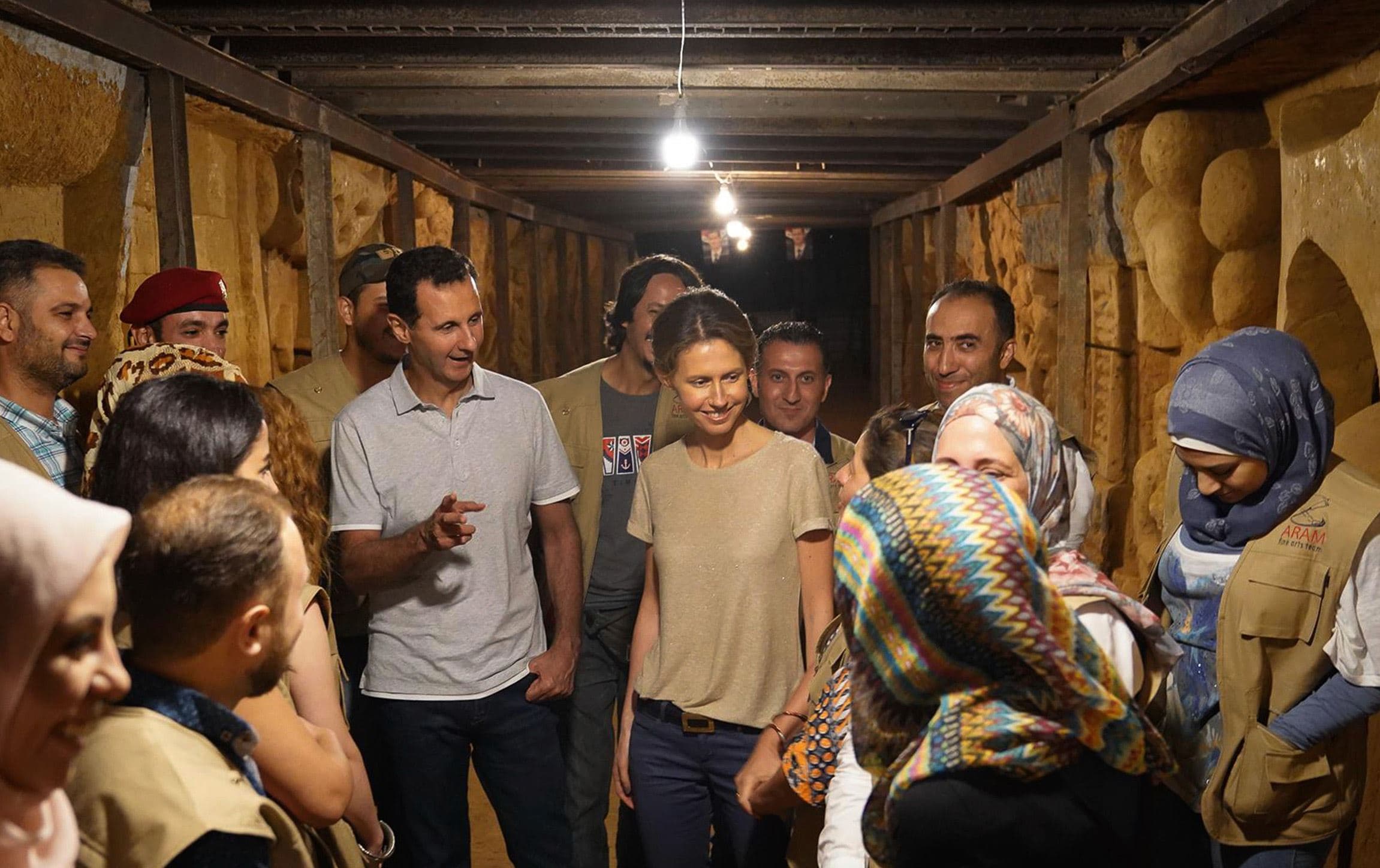 In this Aug. 16, 2018, file photo, Syrian President Bashar Assad, center left, and his wife Asmaa, meet with charity workers. Photo: Syrian Presidency via AP, File