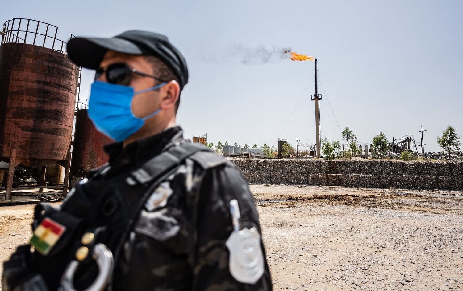 A Kurdistan Region police officer stands on watch at an illegal oil refinery being shut down on June 16, 2020. Photo: Bilind T. Abdullah/Rudaw
