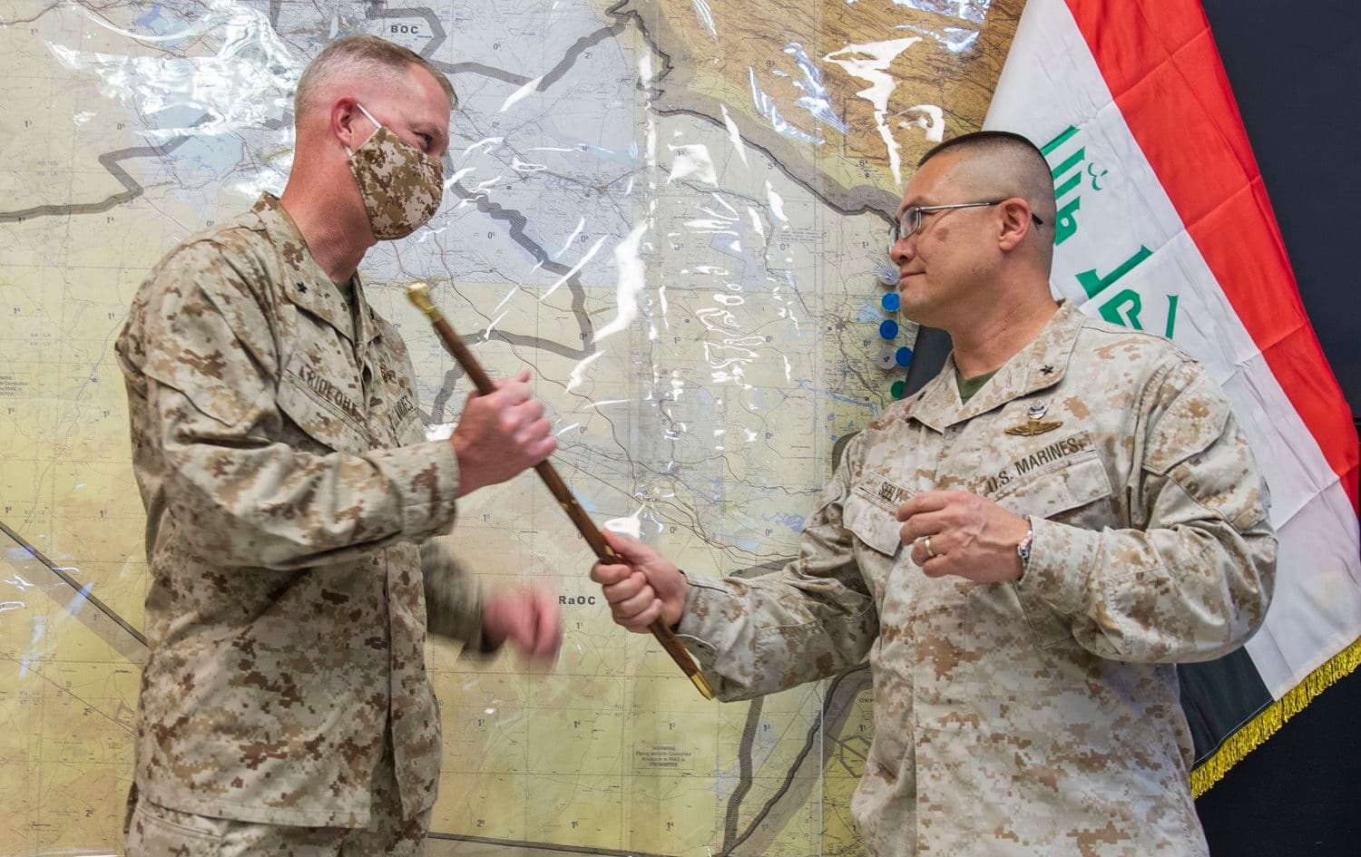 US Marine Brig. Gen. Bill Seely (right), departing commander of Combined Joint Task Force-Operation Inherent Resolve's Task Force Iraq, passes the ceremonial "swagger stick" to U.S. Marine Brig. Gen. Ryan Rideout, incoming Military Advisory Group director. Photo: Sgt. Temos Wooten / US Army 