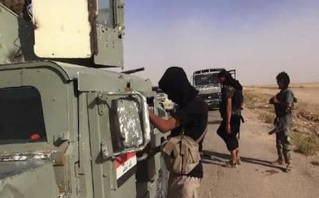 Fighters of the Islamic State of Iraq and Syria (ISIS) inspecting military vehicles abandoned by the Iraqi army. Photo: AFP