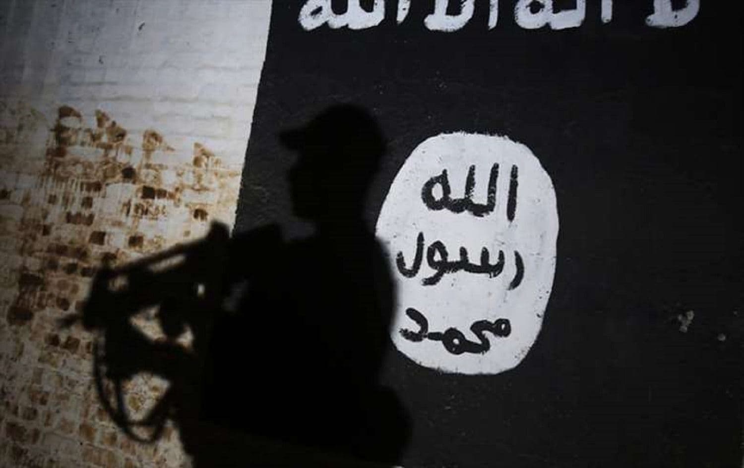 A member of the Iraqi security forces walks past a mural bearing an ISIS logo outside Mosul in March 2017.File photo: Ahmad al-Rubaye/AFP