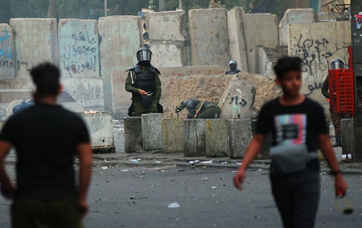  Security forces and protesters are in seen in Baghdad on February 22, 2020. Photo: Hadi Mizban/AP