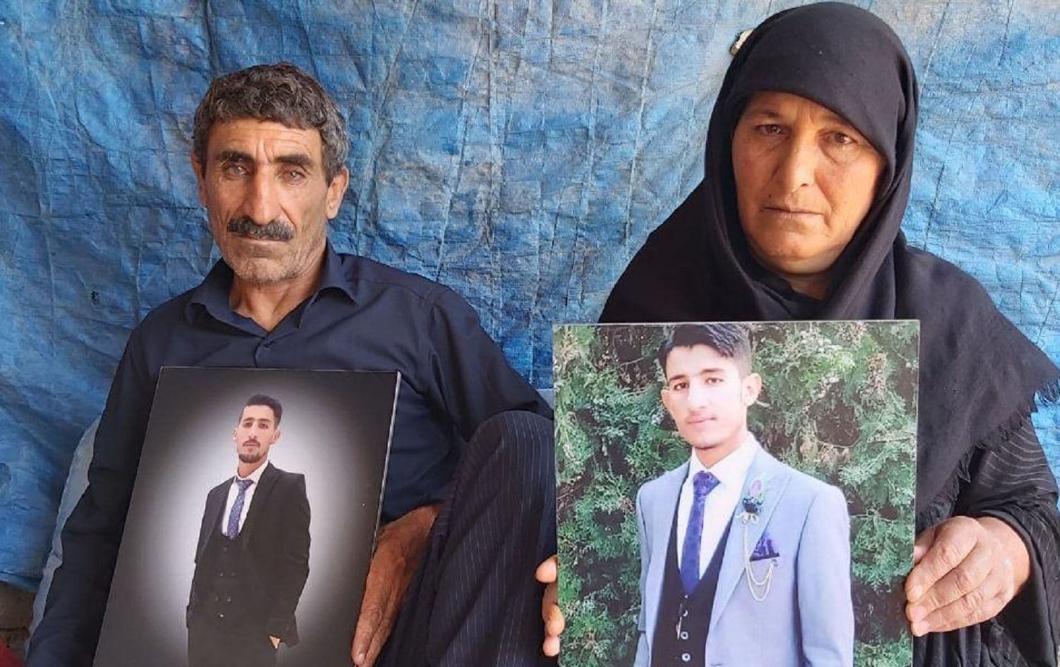 Hakem Ahmadi (left) holds a photo of son Arsalan, shot dead by Turkish border guards in May; Jawahir Ahmadi holds a photo of son Shamzin, killed by Iranian border guards on July 1. Photo: Jabar Dastbaz / Rudaw 