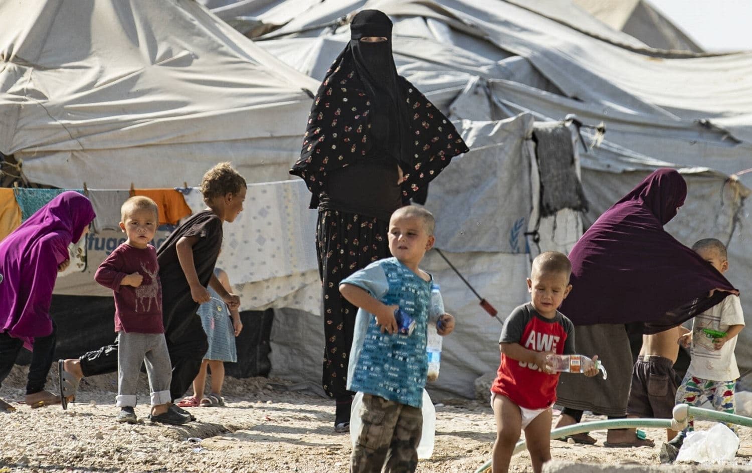 Women look after children at the Kurdish-run al-Hol camp in northeastern Syria's Hasaka province, where families of foreign ISIS fighters are held, on October 17, 2019. Photo: Delil Souleiman / AFP
