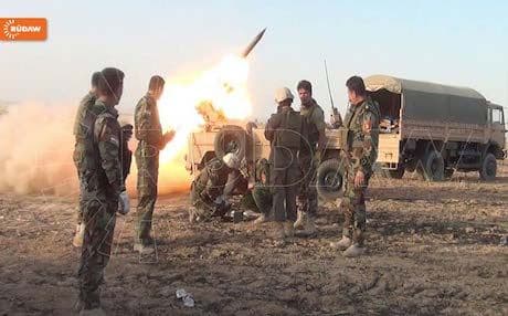 Peshmerga forces aim artillery fire against ISIS positions south of Kirkuk.