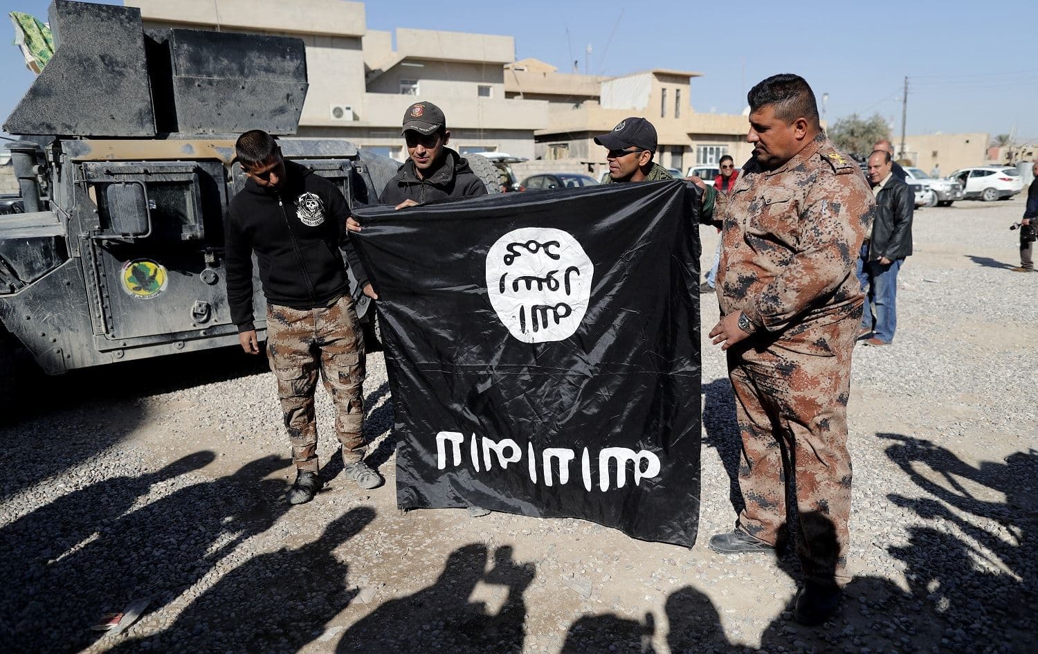 Iraqi soldiers pose with an upside-down Islamic State (ISIS) on the outskirts of Mosul on November 23, 2016. File photo: Thomas Coex/AFP