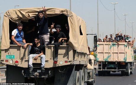 Iraqi Shiite volunteers leaving a recruitment center in Baghdad on their way to fight the Islamic State (IS). Photo: AFP