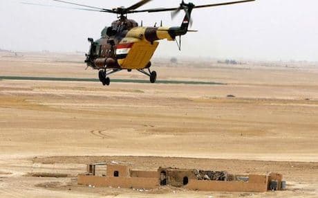 An Iraqi helicopter attacking ISIS-held positions near Tikrit. Photo: AFP