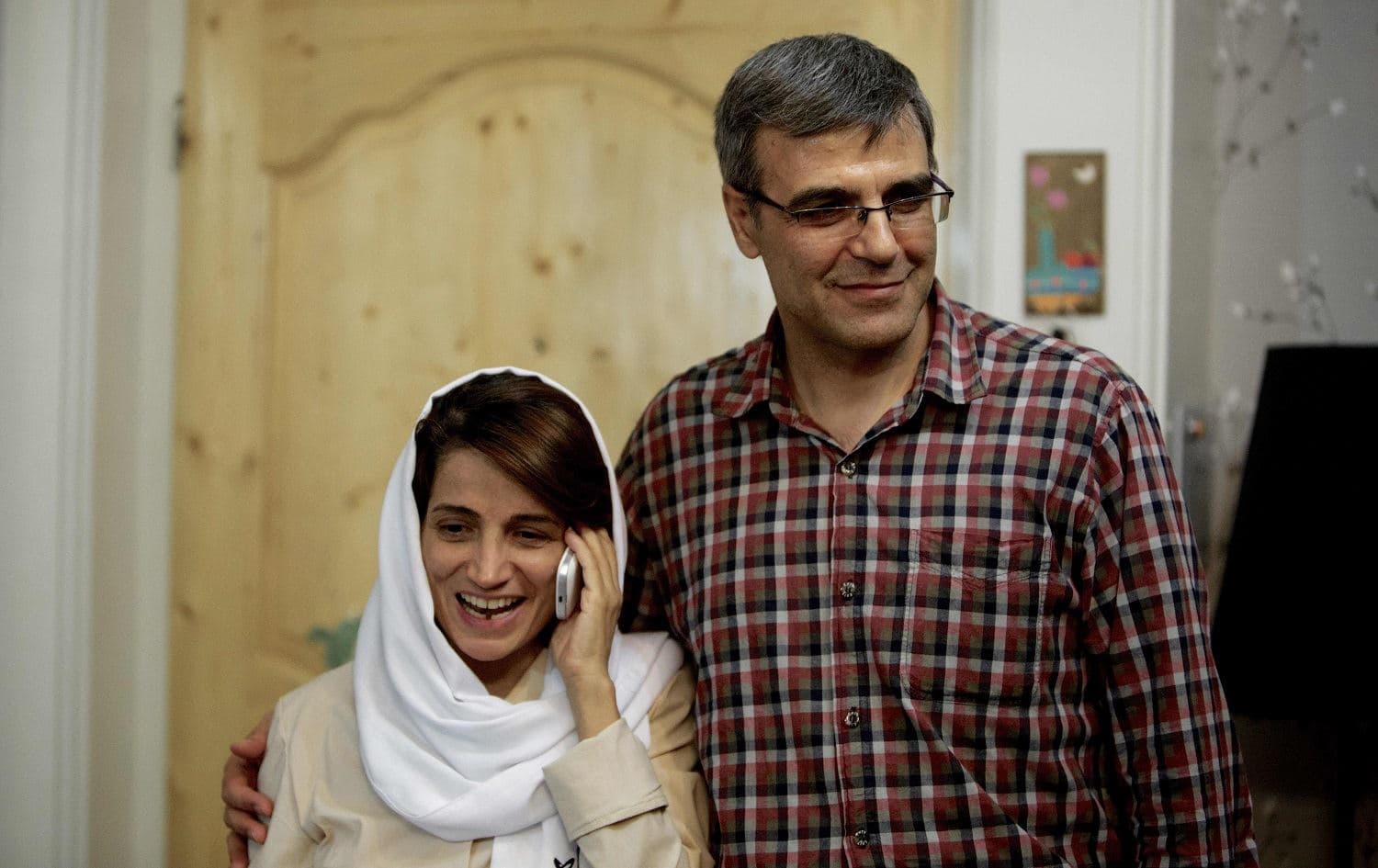 Iranian lawyer Nasrin Sotoudeh (L) speaks on the phone next to her husband Reza Khandan as they pose for a photo at their house in Tehran on September 18, 2013. File photo: Behrouz Mehri/AFP