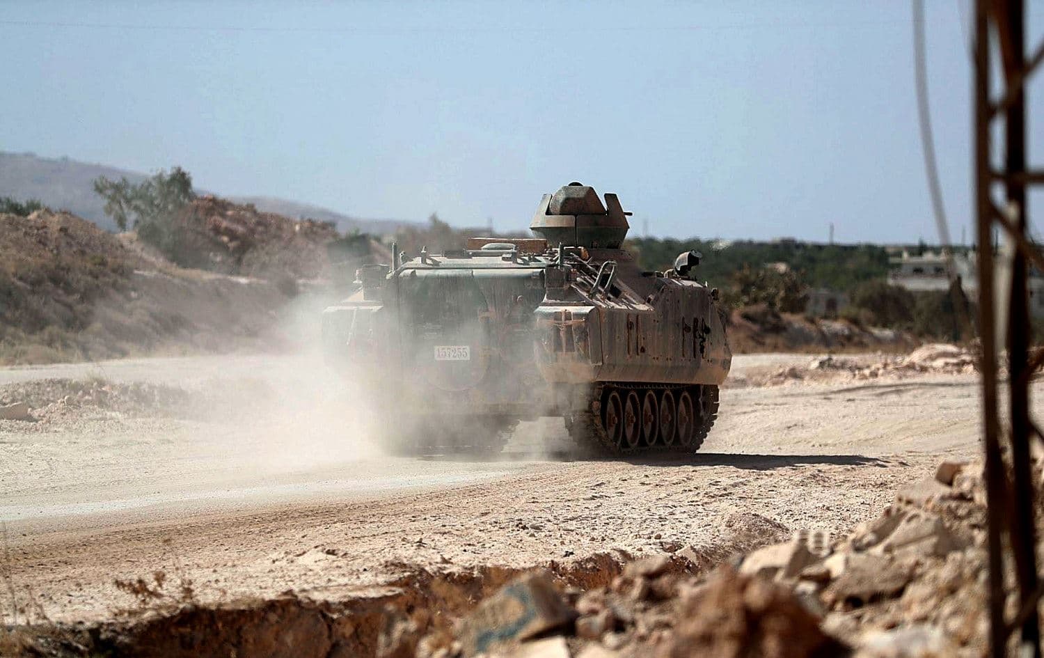 A Turkish military armoured vehicle advances on a road in the village of al-Nayrab on October 20, 2020. Photo: Omar Haj Kadour/AFP