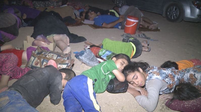 Exhausted Turkmen families lost in sleep after arriving in Kurdistan.