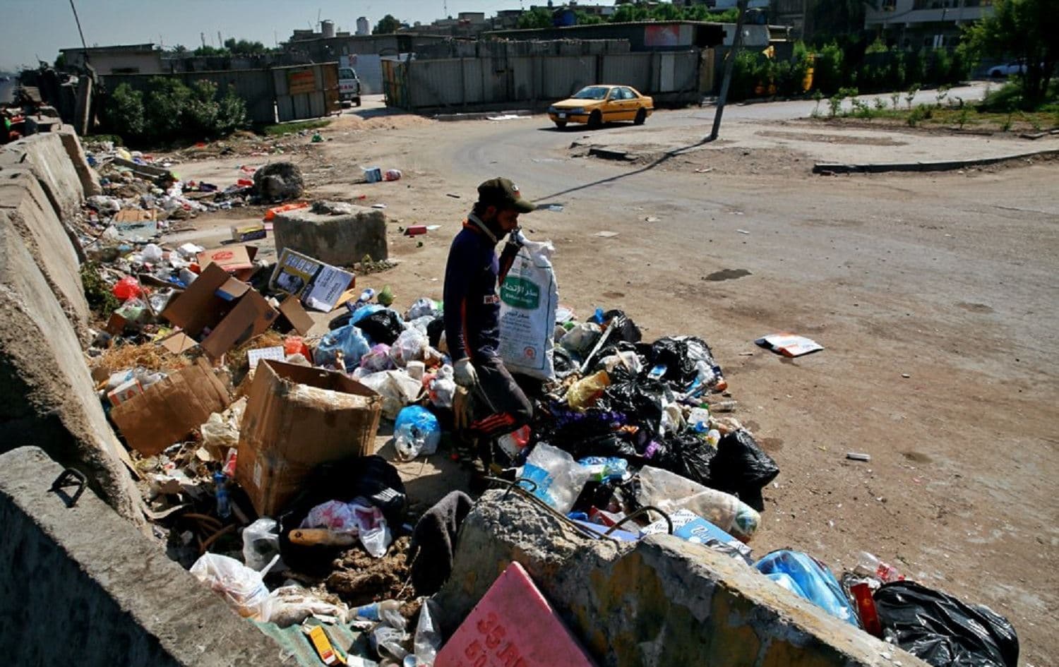 A man searches for recycled items in a landfill in Baghdad, Iraq on October 20, 2020. Photo: Khalid Mohammed/AP