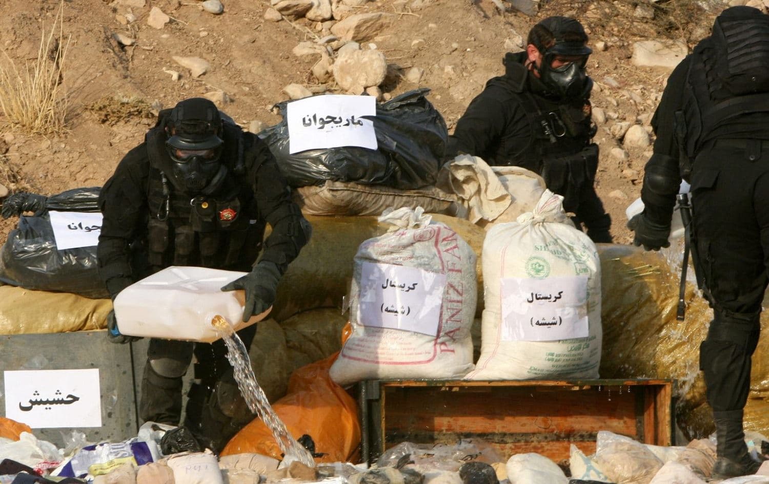 A member of the Asayish stands next to a pile of seized drugs about to be burned in Erbil on Oct 29, 2013. File photo:Safin Hamed/AFP