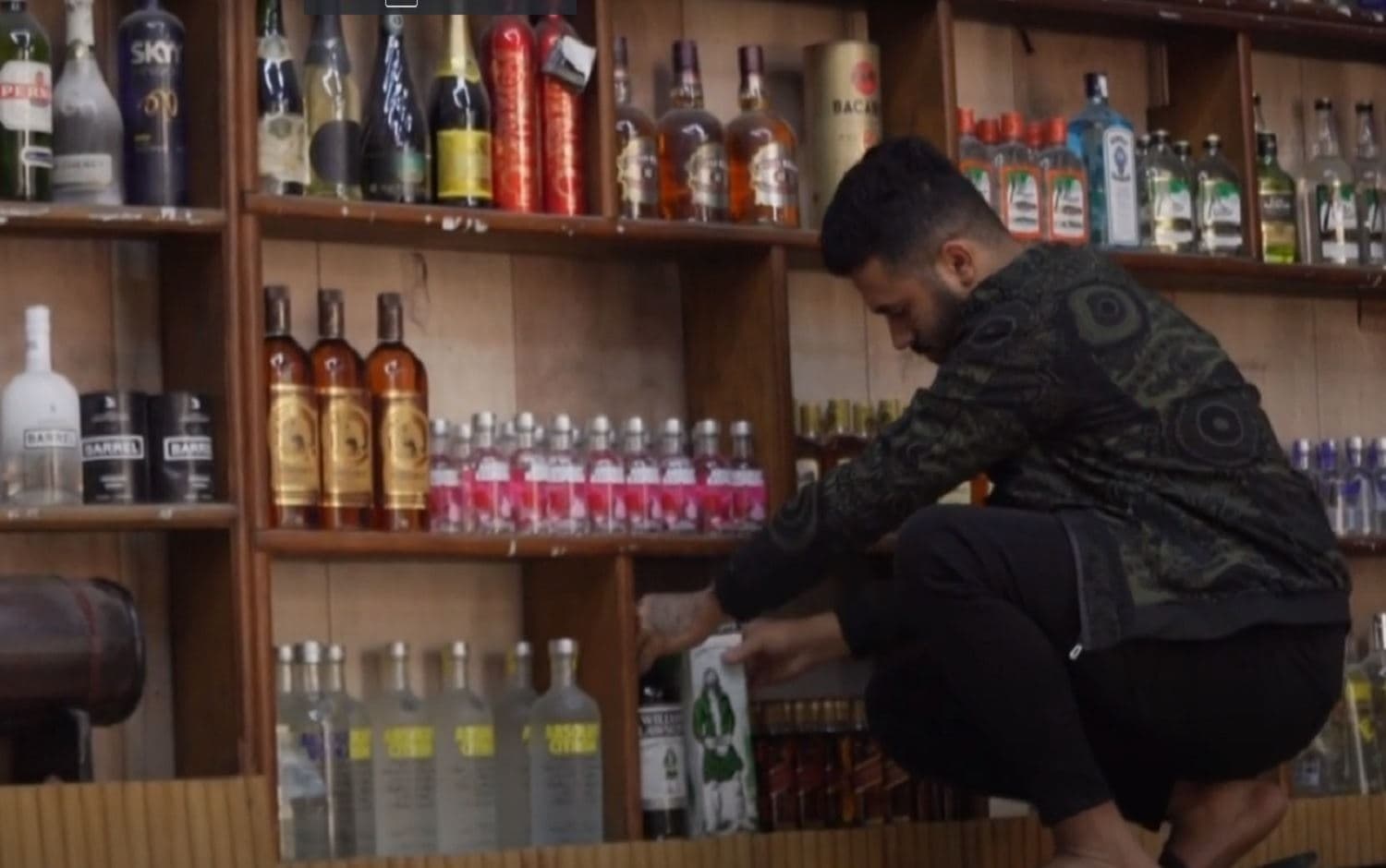 A liquor store employee stocks shelves in Baghdad in December 2020. Photo: AFP