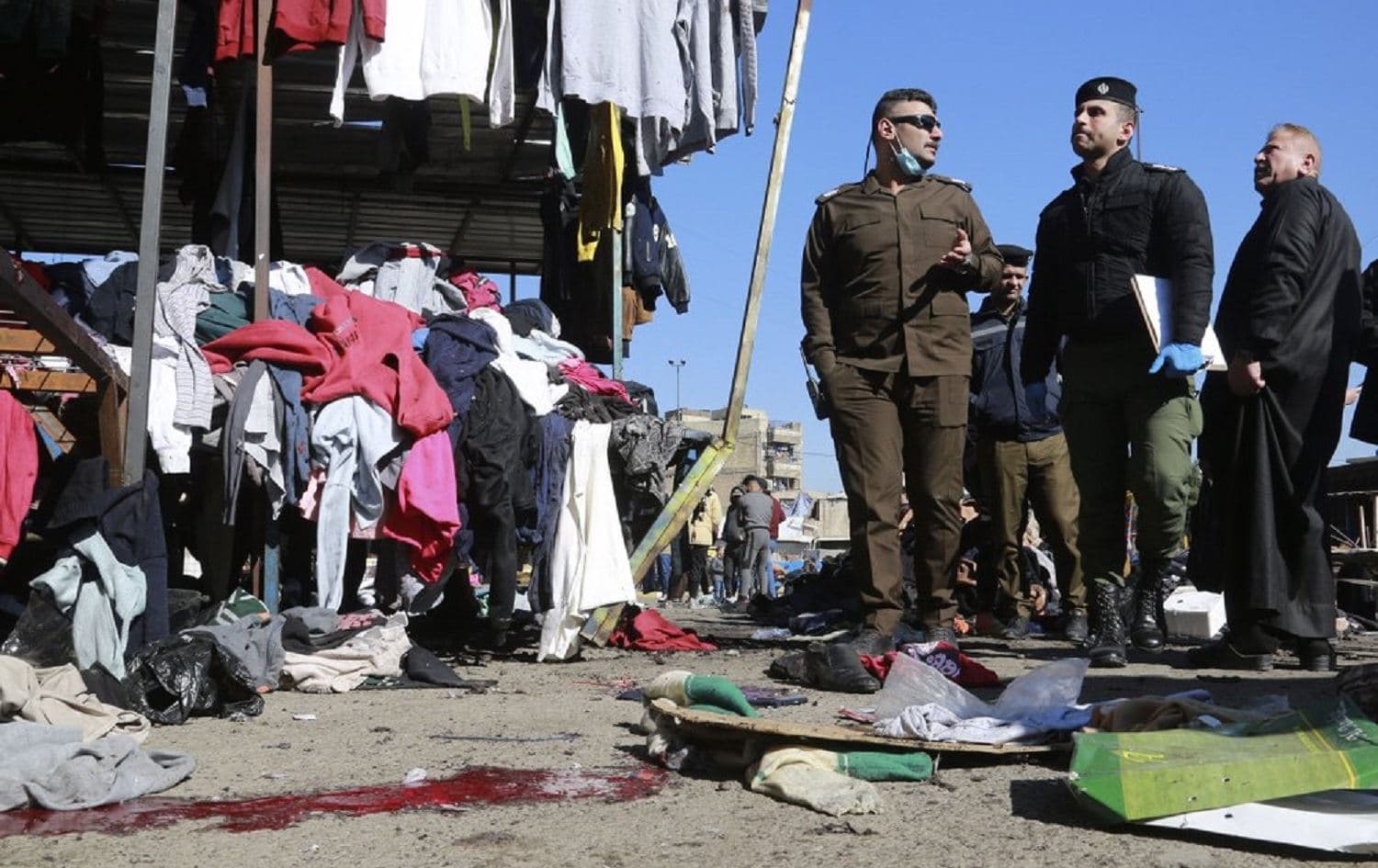 Security forces work at the site of a deadly bomb attack in a market selling used clothes in Baghdad, Iraq on January 21, 2021. Photo: Hadi Mizban/AP