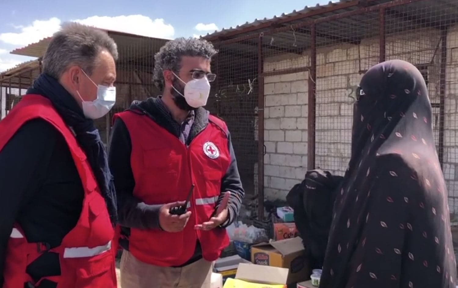 Peter Maurer, president of the International Committee of the Red Cross (ICRC), left, speaks with a woman in Syria’s al-Hol camp, in a screengrab taken from video published on March 26, 2021. Photo: screengrab/ICRC video