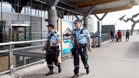 Armed police patrol outside the terminal building at Oslo Airport. Norway has been on its highest alert. Photo: AP