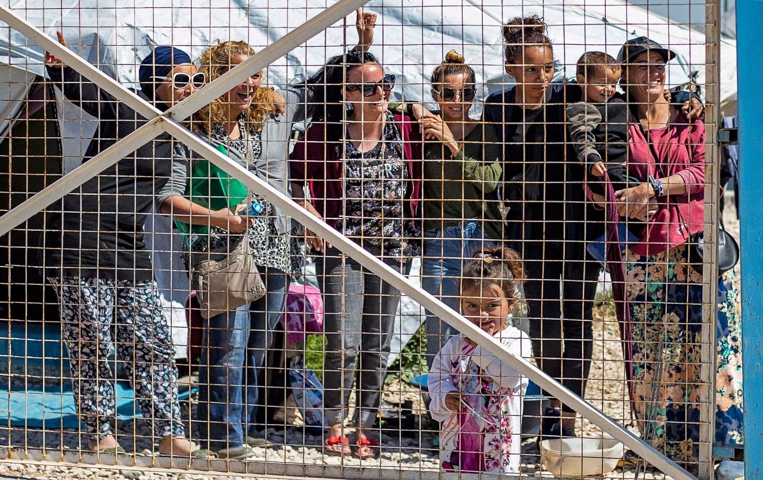 A group of women, reportedly the wives of suspected Islamic State (ISIS) group fighters, pose on March 28, 2021 for a picture at Camp Al-Roj, where relatives of suspected ISIS members are held, in the countryside near al-Malikiyah (Derik) in Syria's northeastern Hasakah province. Photo: Delil Souleiman/ AFP