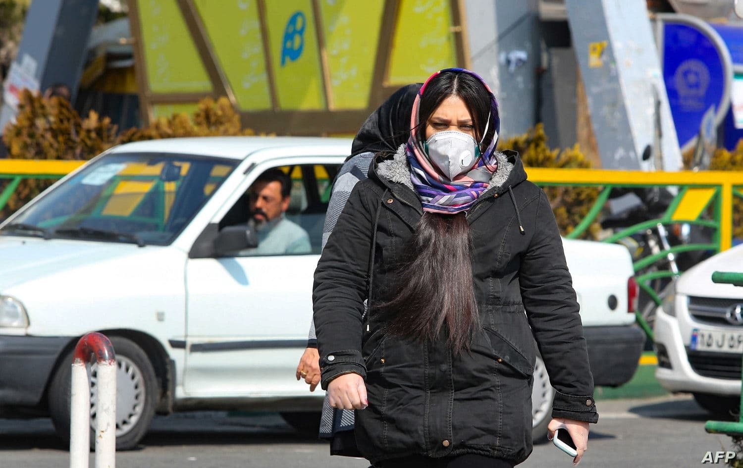 A masked woman walks in Tehran. File photo: AFP