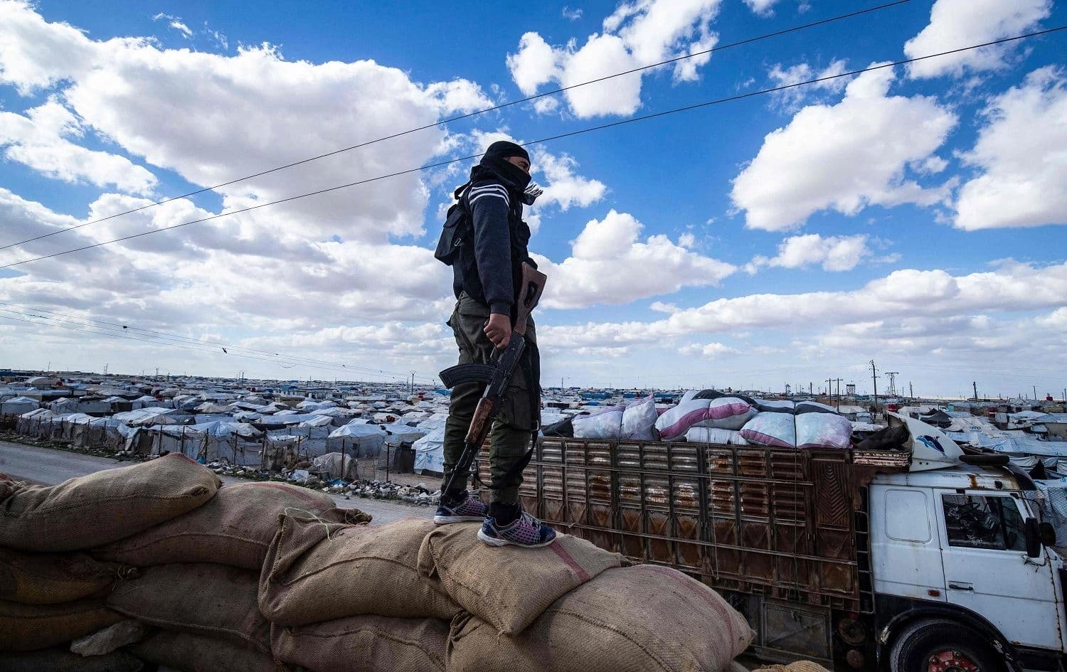 A member of Kurdish security forces looks out over al-Hol camp in northeast Syria (Rojava) on March 18, 2021. File photo: Delil Souleiman/AFP