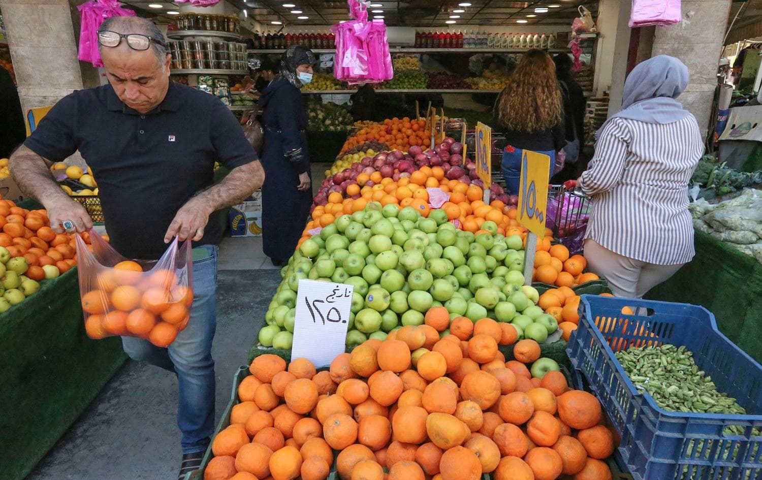 People buy fresh produce at a shop in the Iraqi capital Baghdad, on April 11, 2021 ahead of the Muslim holy month of Ramadan. Photo: Sabah Arar/ AFP